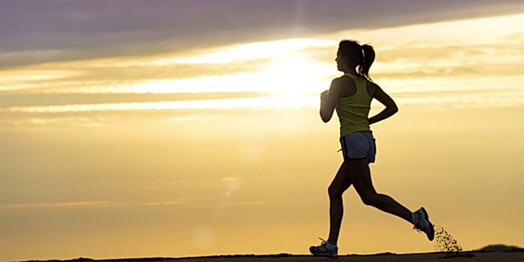 Athlete running at sunset on beach